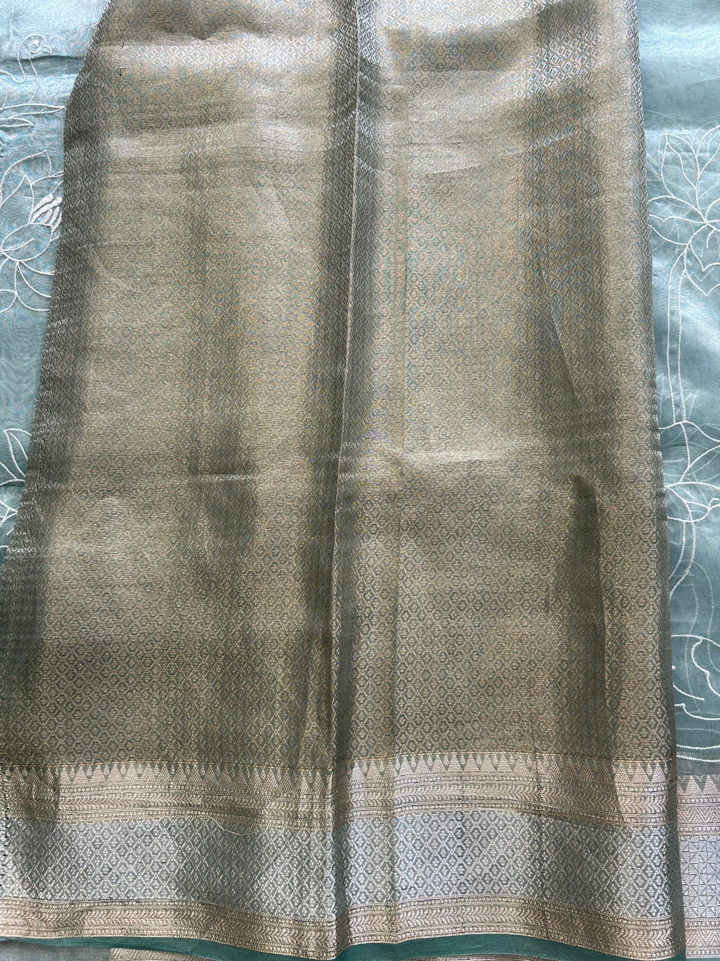 Banarasi Kora Saree Sea Foam Green Colored Complemented with a Silver And Gold Zari Border.