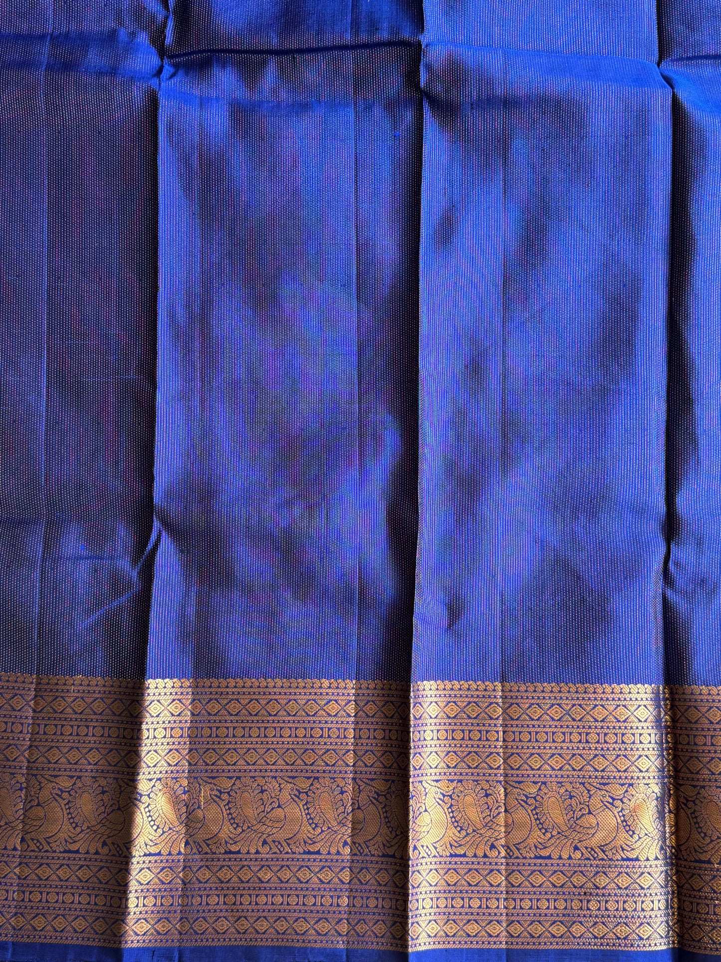 Pure Kanjivaram Silk Saree Dark Blue Colored Elegantly Paid with a Gold Zari Border.