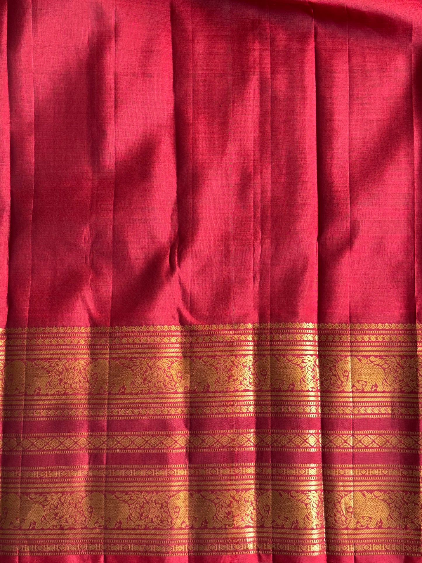 Pure Kanjivaram Silk Saree Burgundy Colored Complemented with a Gold Zari Border.
