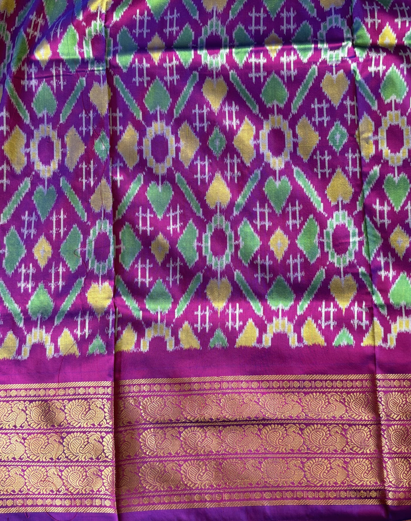 Ikkat Pattu Saree Olive Green colored complemented with a Kanchi border. - Sampradaya Designer Studio