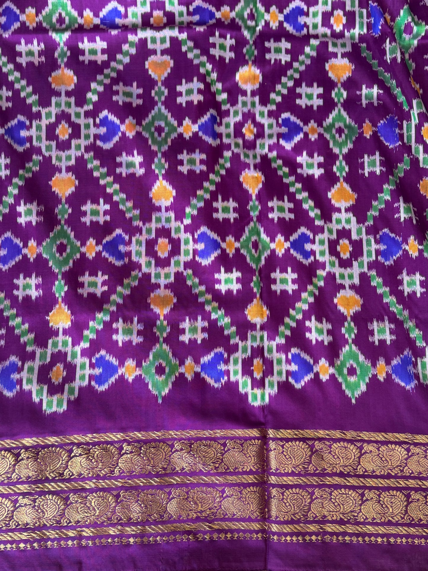 Ikkat Pattu Saree Olive Green colored complemented with a Purple Kanchi border. - Sampradaya Designer Studio