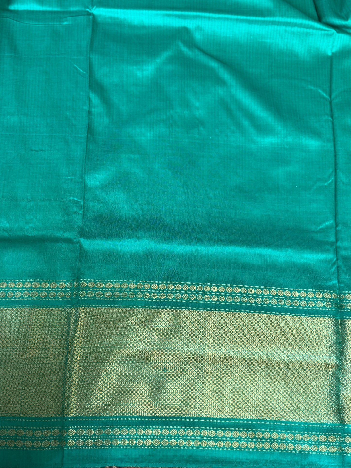 Ikkat Pattu Saree Purple colored complemented with a Sea Green Kanchi border. - Sampradaya Designer Studio