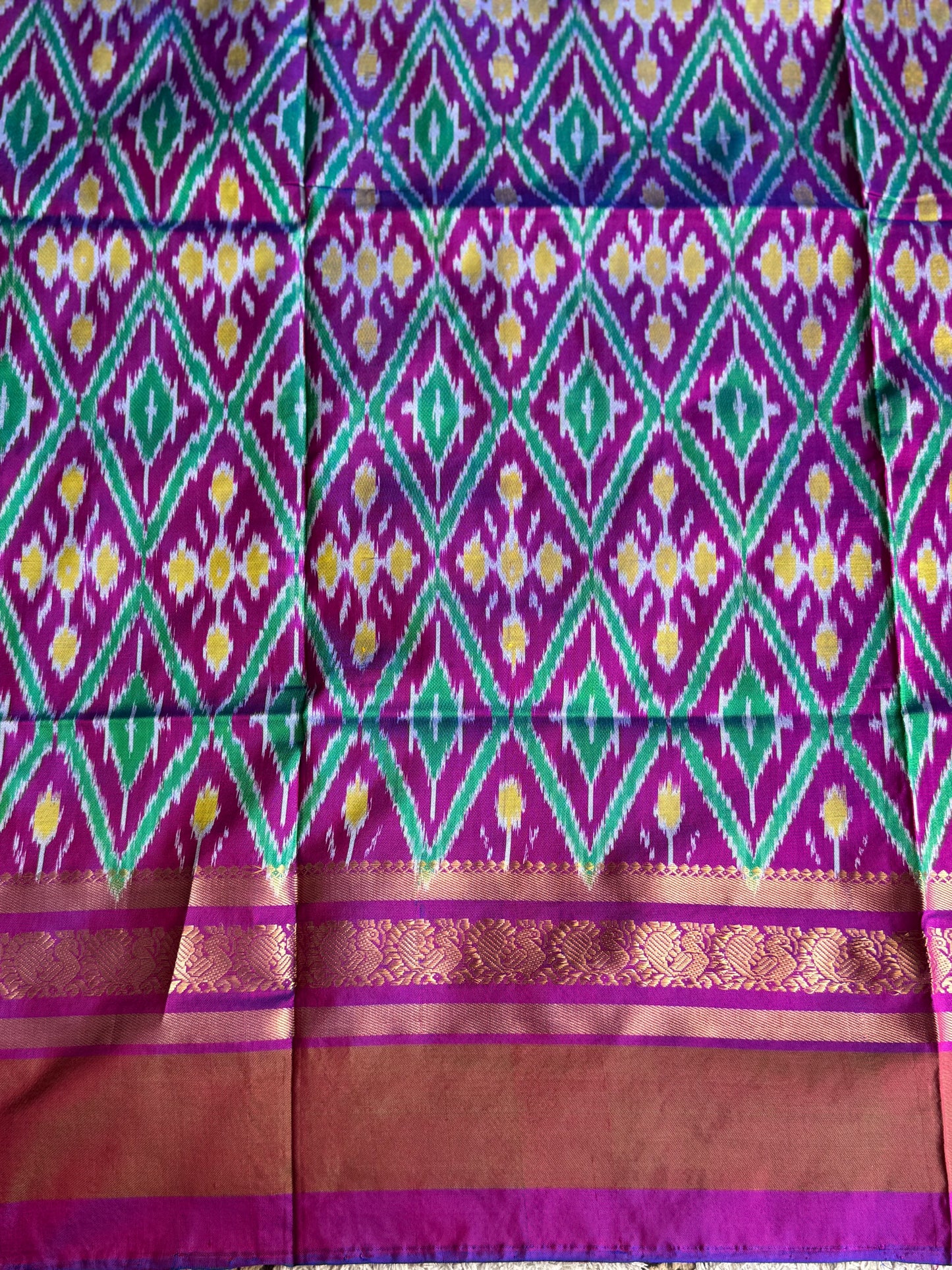 Ikkat Pattu Saree Dark Maroon colored complemented with a Kanchi border. - Sampradaya Designer Studio