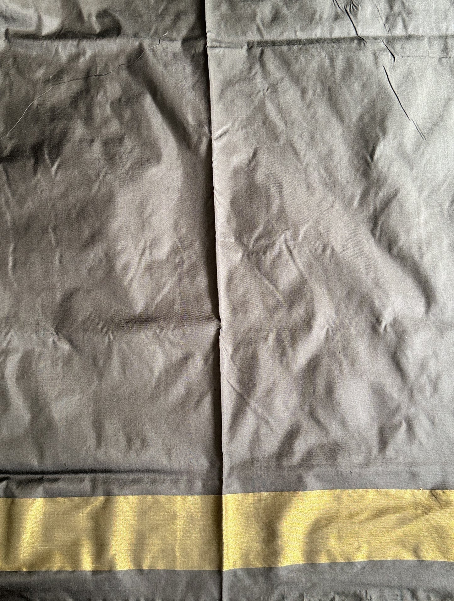 Ikkat Pattu Saree Gray colored complemented with a Black Zari border. - Sampradaya Designer Studio