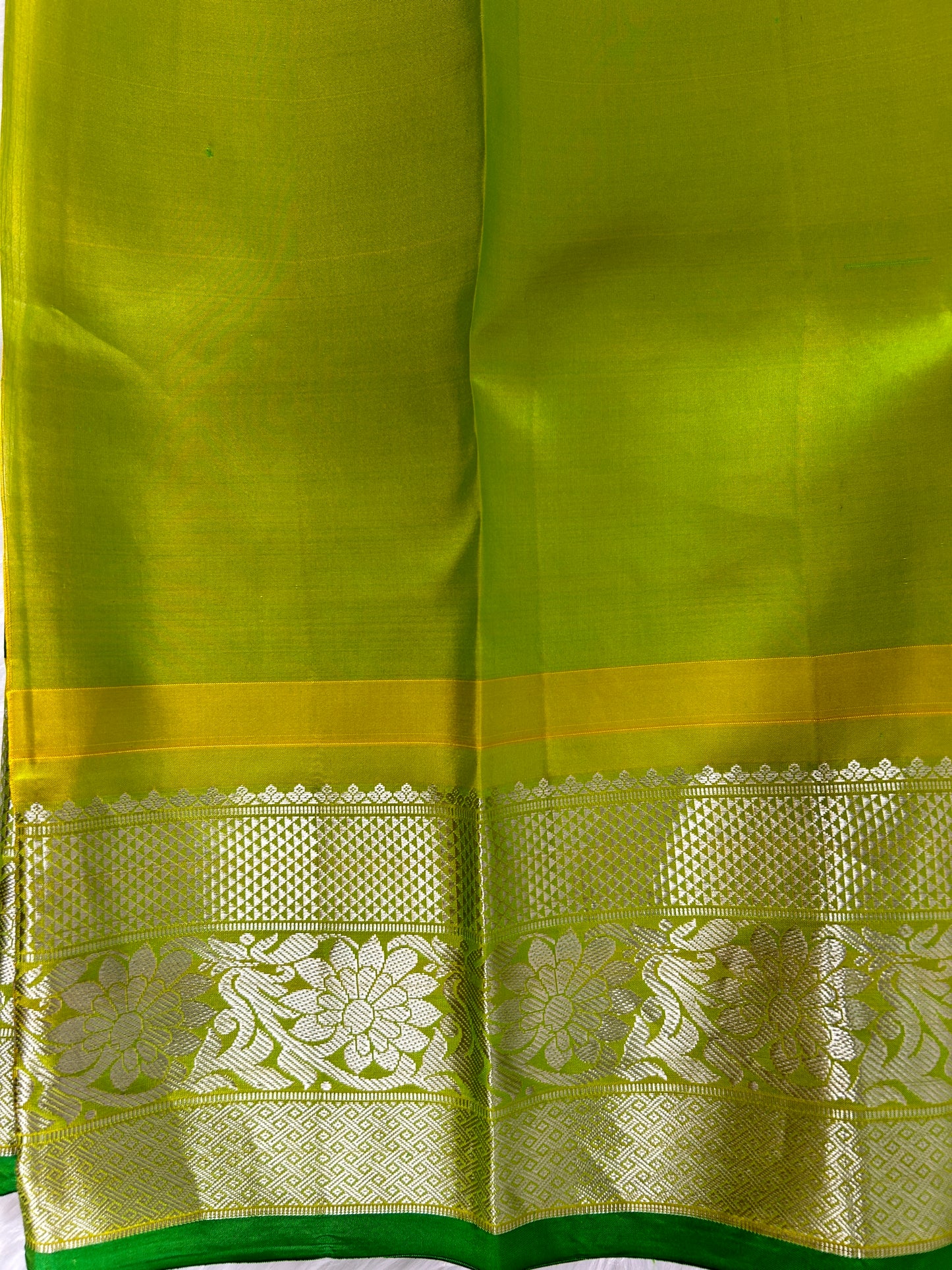 Gadwal Pattu Saree Bottle Green-colored saree complemented with a Lemon Yellow border - Sampradaya Designer Studio