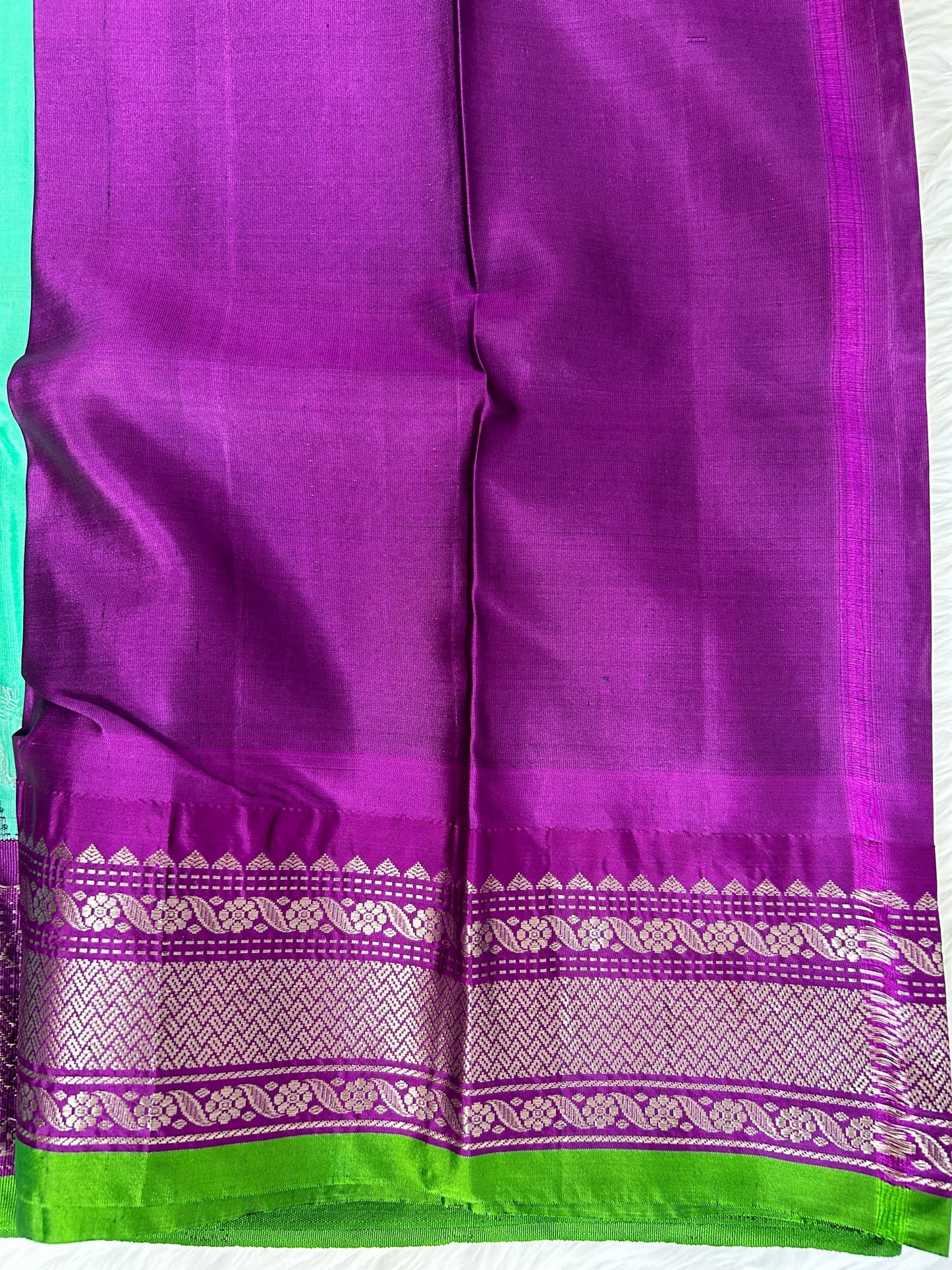 Gadwal Pattu Saree Greenish Cyan colored saree complemented with a Purple Kanchi border - Sampradaya Designer Studio
