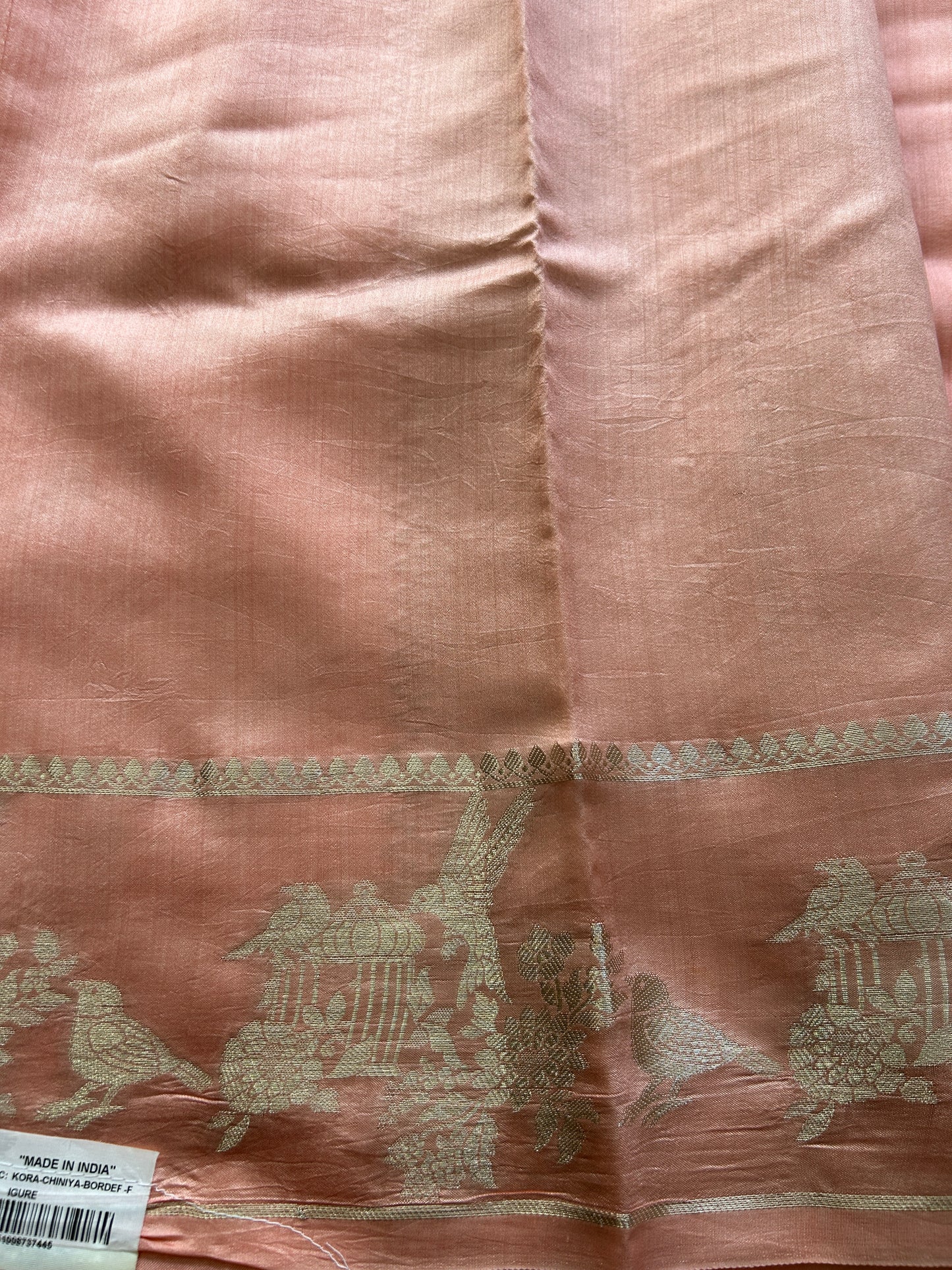 Pure Chiniya Silk Saree Peach Colored Elegantly Paired with a Gold Zari Border.