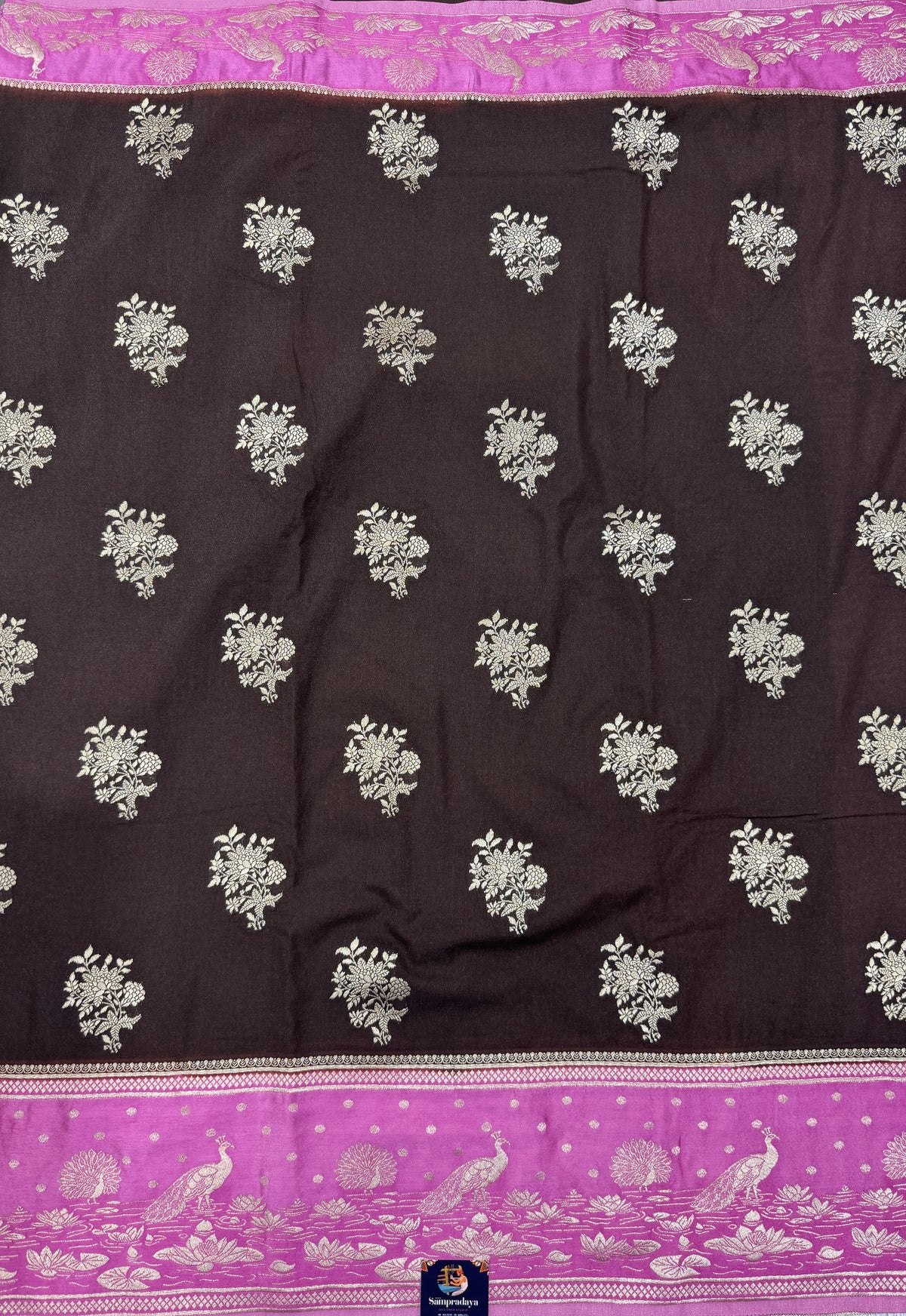 Banarasi Fancy Saree Brown Colored Complemented with a Pink Zari Border.