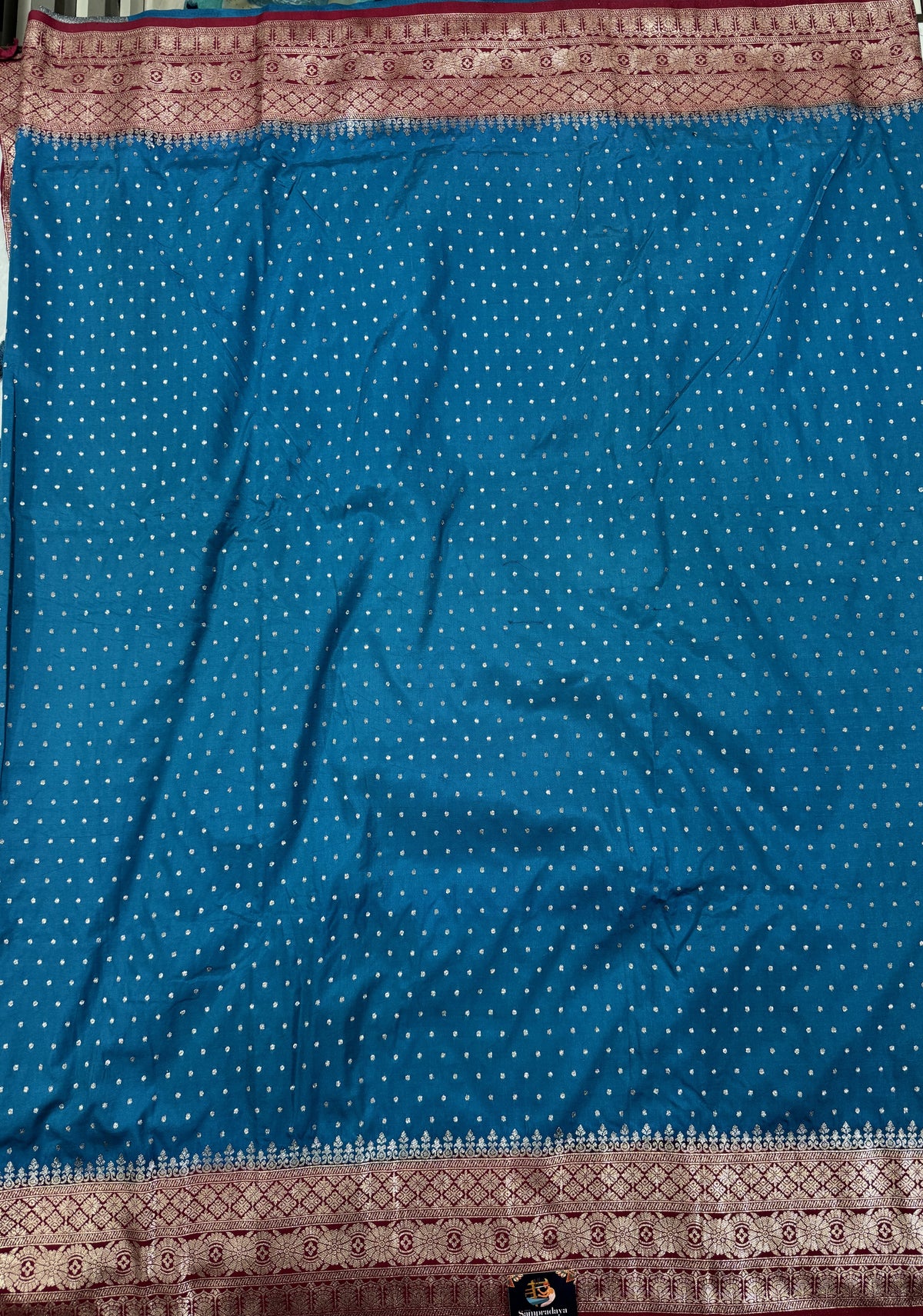 Banarasi Fancy Saree Teal Blue Colored Complemented with a Magenta Zari Border.