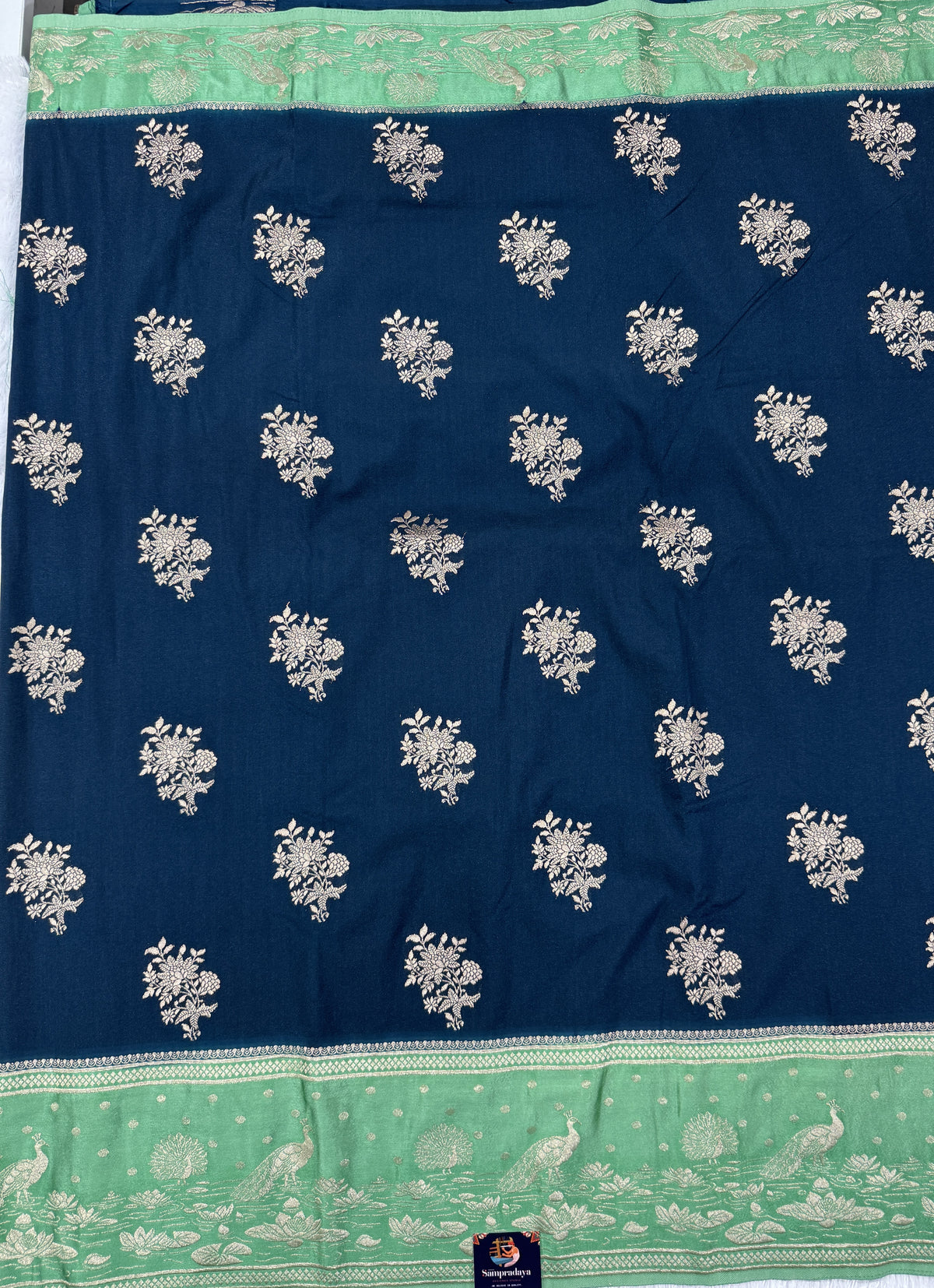 Banarasi Fancy Saree Dark Teal Blue Blue Colored Complemented with a Light Green Zari Border.
