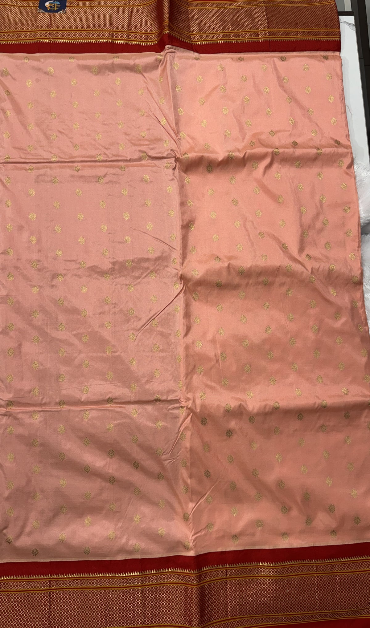 Narayanpet Silk Saree Peach Colored Complemented with a Red Zari Border.
