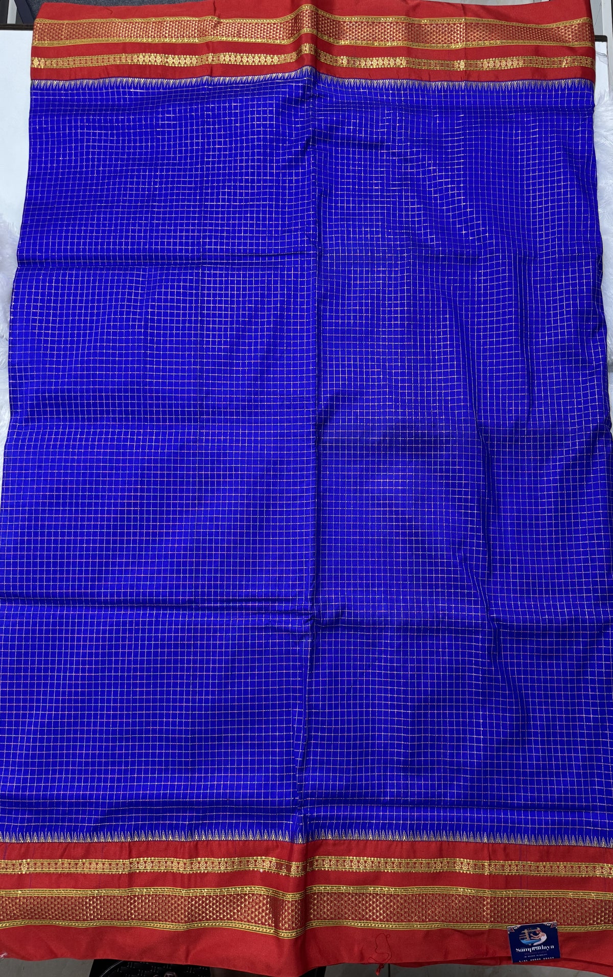 Narayanpet Silk Saree Blue Colored Complemented with a Red Zari Border.