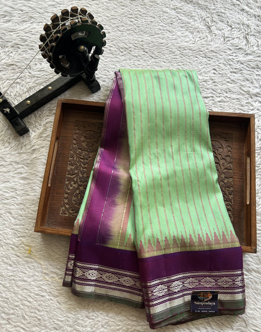 Gadwal Silk Saree Light Green Colored Complemented With Purple and Silver Zari Weaving Border - Sampradaya Designer Studio