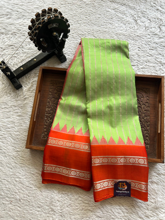 Gadwal Silk Saree Parrot green Colored Complemented With Orange color and Silver Zari Weaving Border - Sampradaya Designer Studio