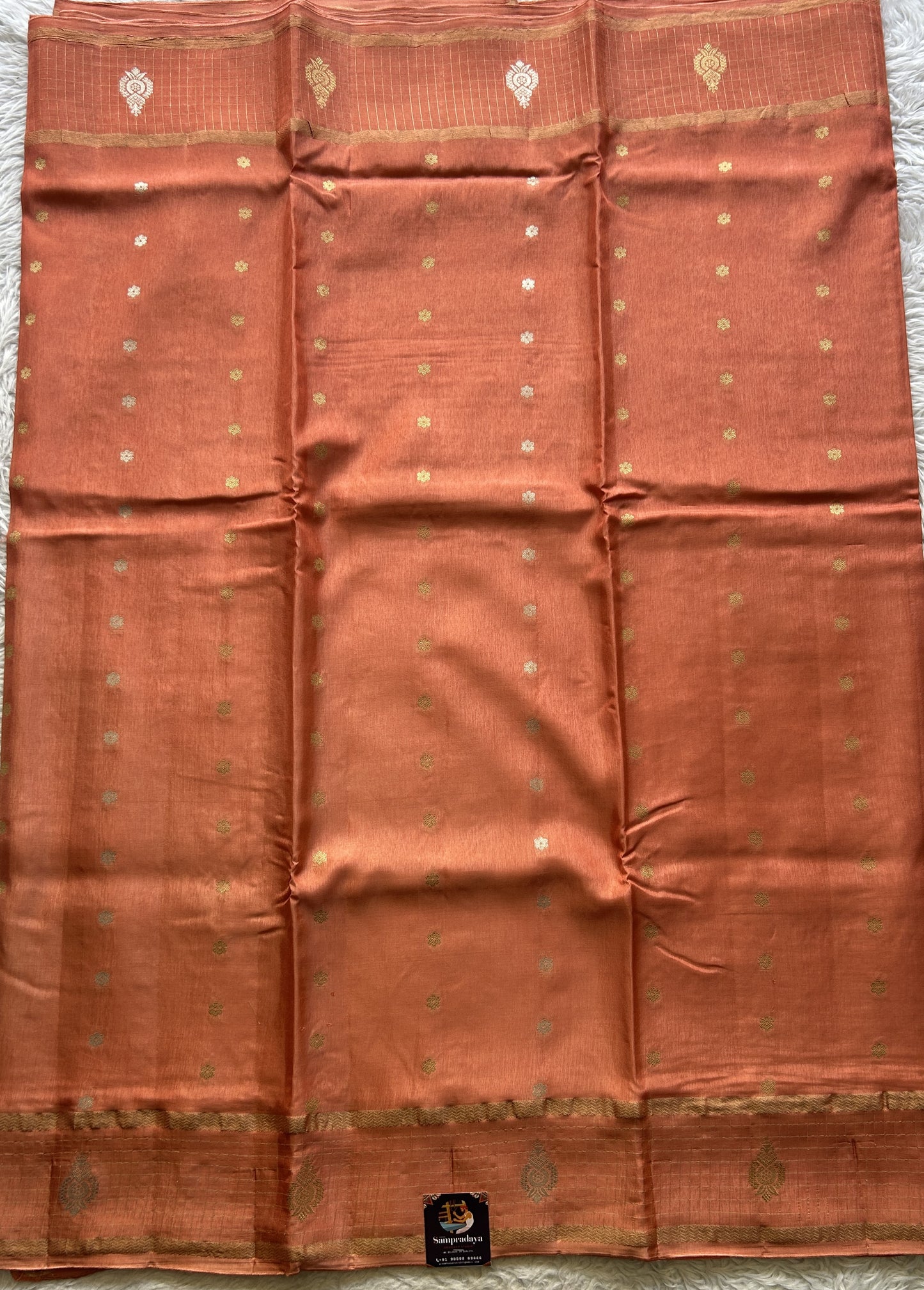 Satin Georgette Saree Pale Orange Colored Elegantly Paired with a Zari Border. - Sampradaya Designer Studio
