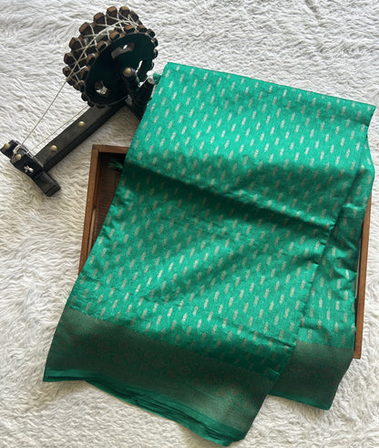 Semi Raw Silk Saree Rama Green Colored Elegantly paired with a Silver Zari Border. - Sampradaya Designer Studio
