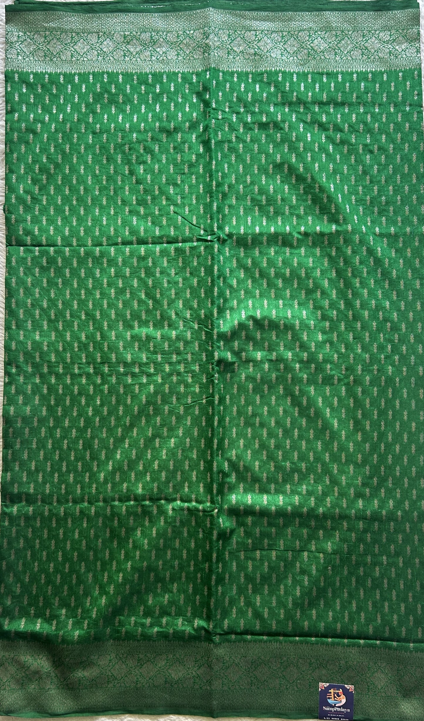 Semi Raw Silk Saree Green Colored Elegantly paired with a Silver Zari Border. - Sampradaya Designer Studio
