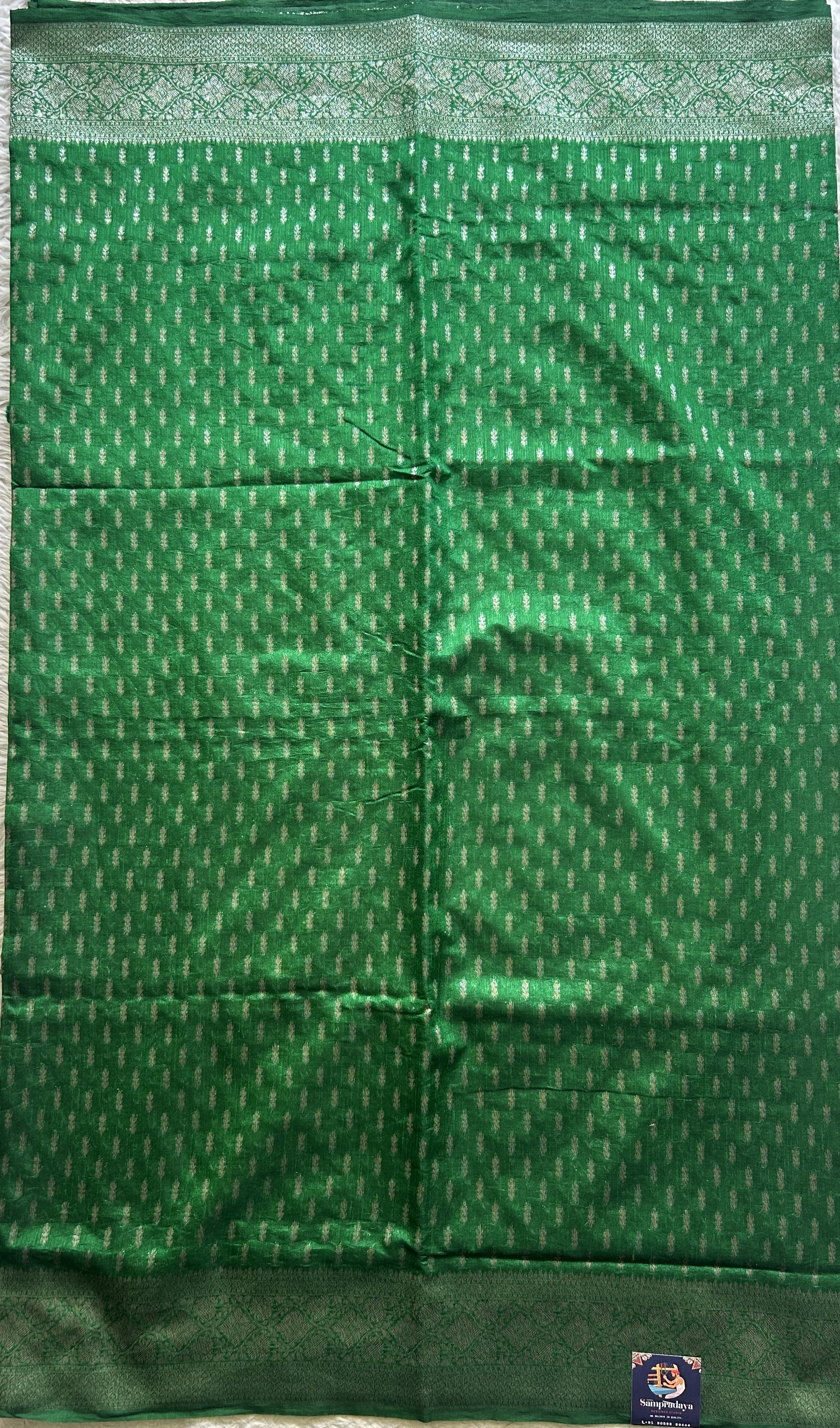Semi Raw Silk Saree Green Colored Elegantly paired with a Silver Zari Border. - Sampradaya Designer Studio