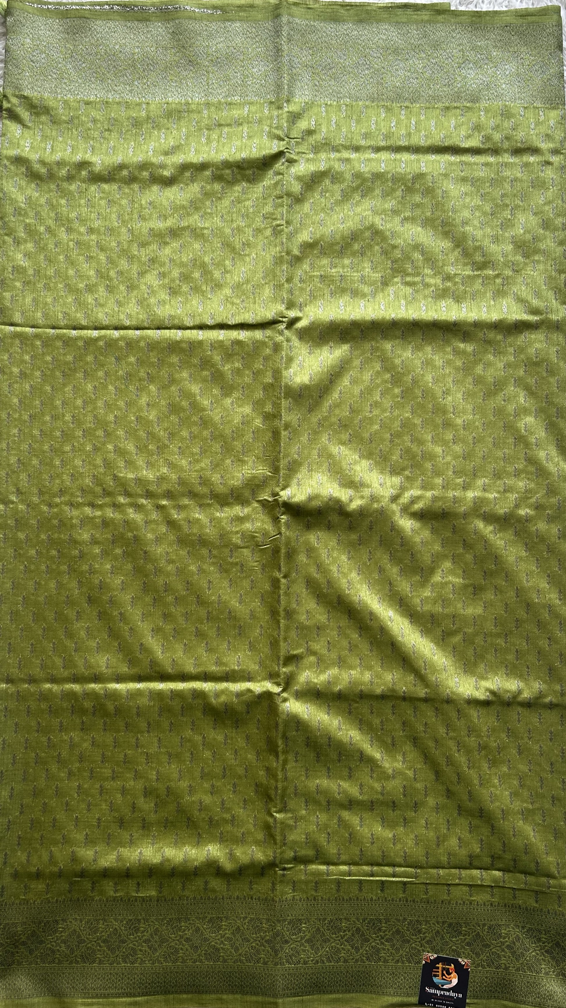 Semi Raw Silk Saree Light Green Colored Elegantly paired with a Silver Zari Border. - Sampradaya Designer Studio