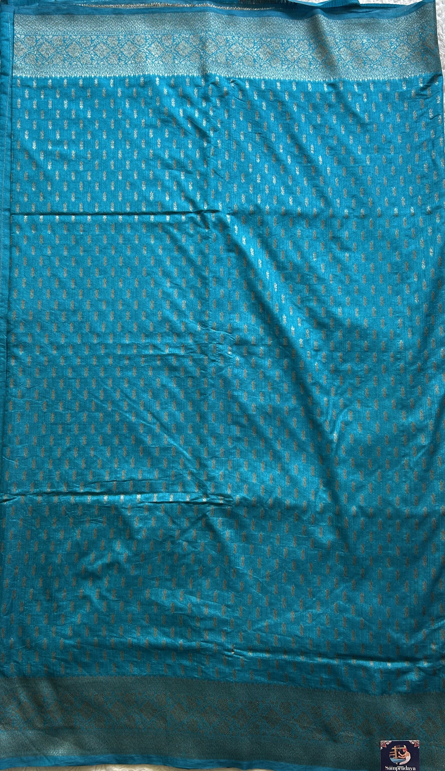 Semi Raw Silk Saree Blue Colored Elegantly paired with a Silver Zari Border. - Sampradaya Designer Studio