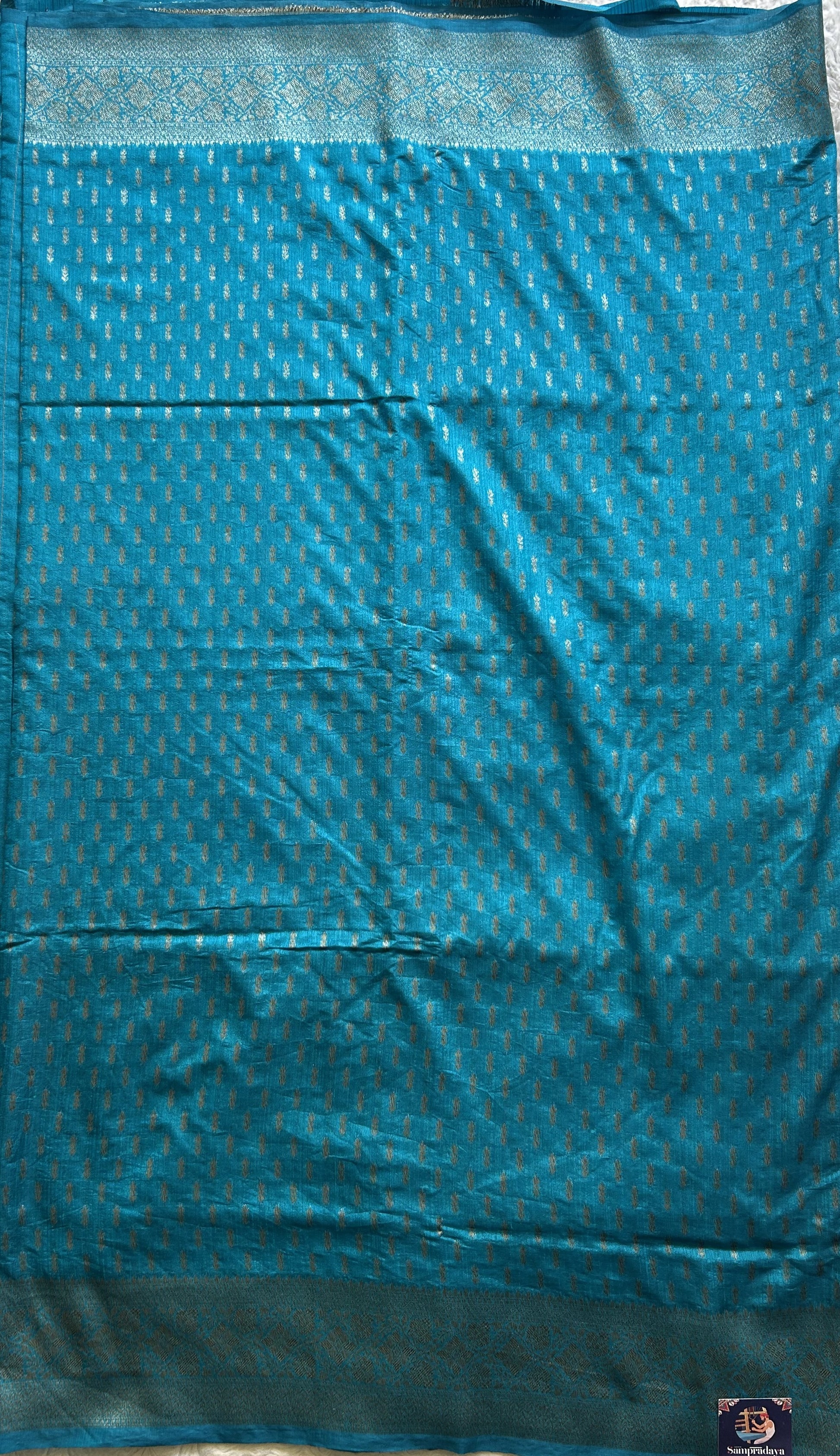 Semi Raw Silk Saree Blue Colored Elegantly paired with a Silver Zari Border. - Sampradaya Designer Studio