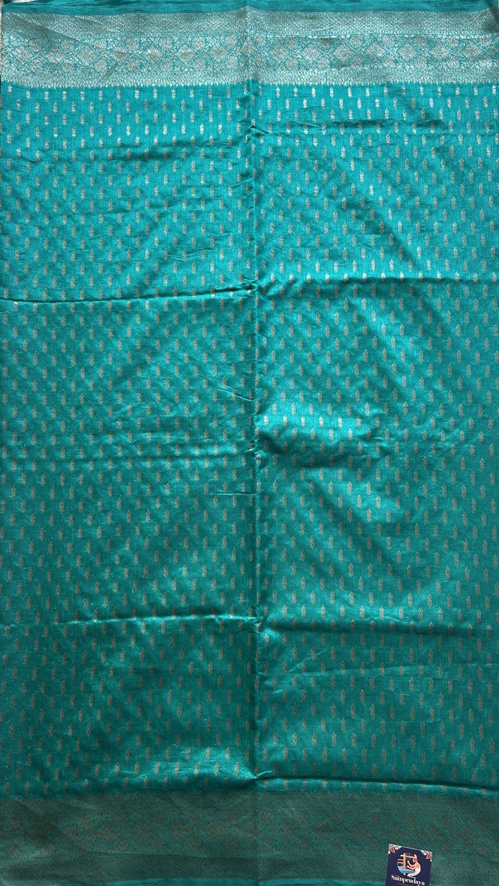 Semi Raw Silk Saree Teal Blue Colored Elegantly paired with a Silver Zari Border. - Sampradaya Designer Studio