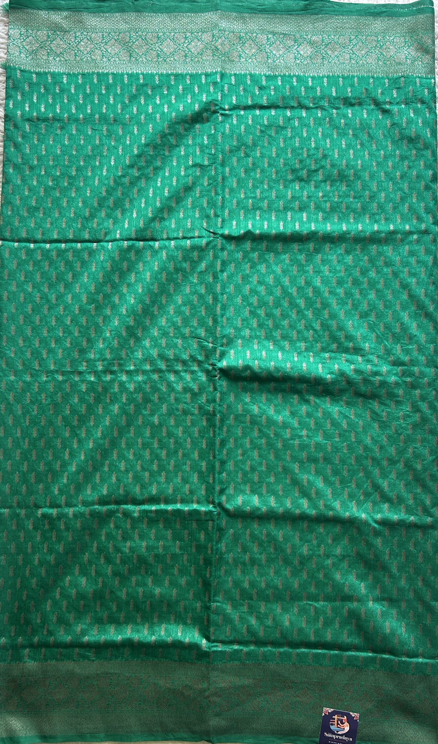 Semi Raw Silk Saree Rama Green Colored Elegantly paired with a Silver Zari Border. - Sampradaya Designer Studio