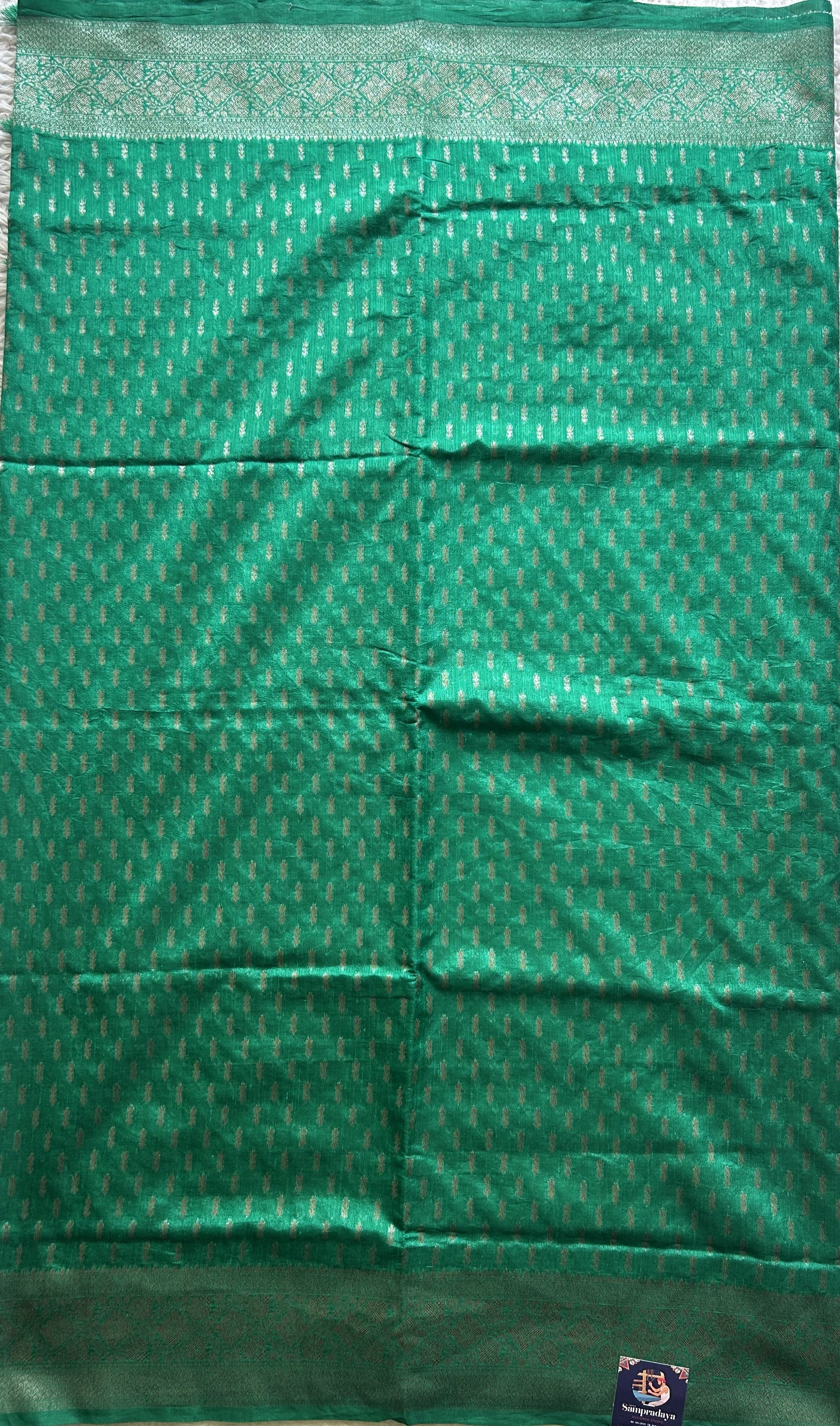 Semi Raw Silk Saree Rama Green Colored Elegantly paired with a Silver Zari Border. - Sampradaya Designer Studio