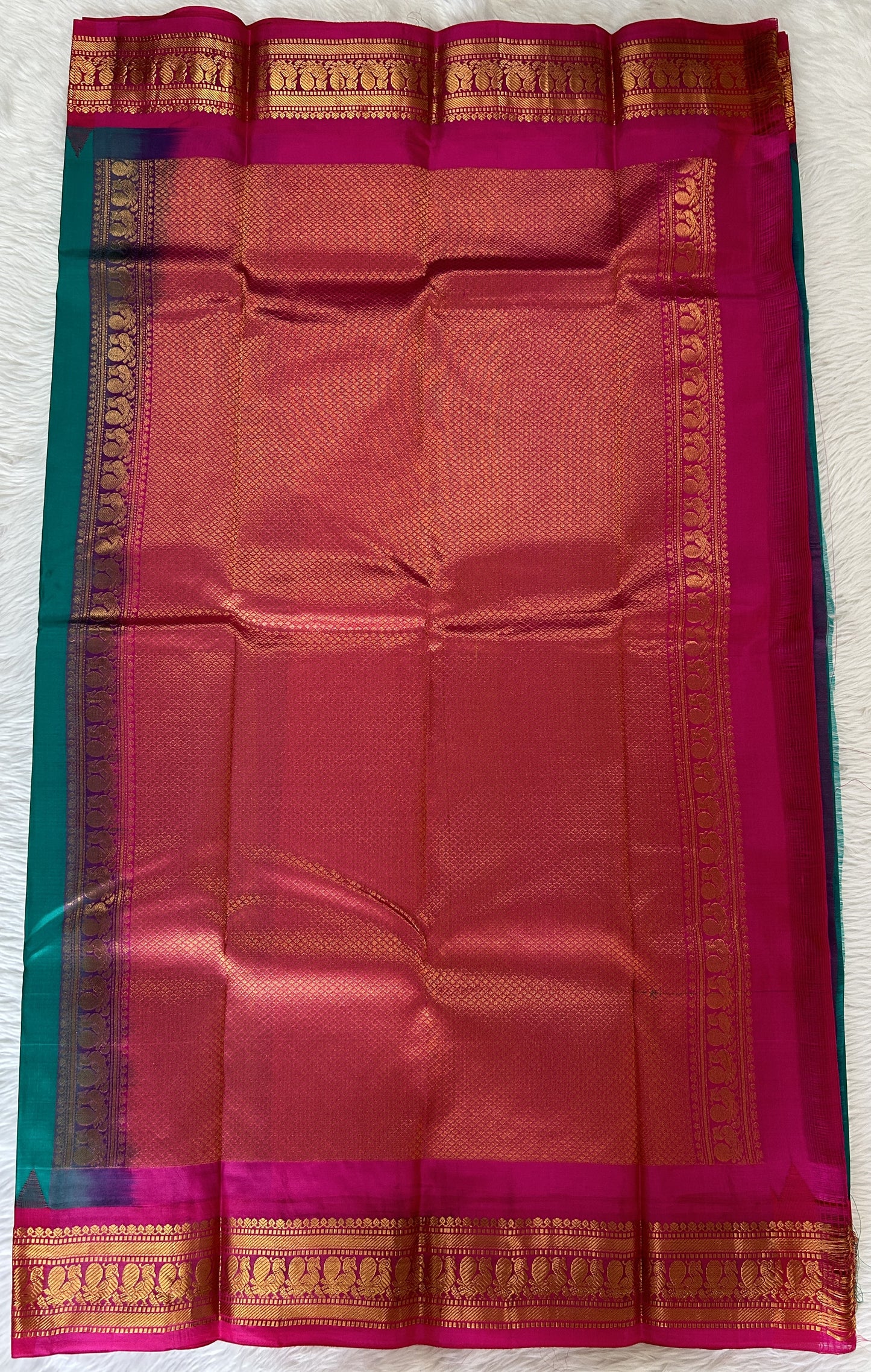 Gadwal Pattu Saree Emerald Green colored saree complemented with a Pink Kanchi Border - Sampradaya Designer Studio