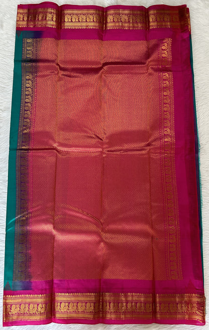 Gadwal Pattu Saree Emerald Green colored saree complemented with a Pink Kanchi Border - Sampradaya Designer Studio
