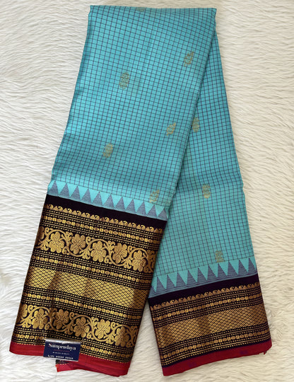 Gadwal Pattu Saree Fountain Blue colored saree complemented with a Dark Violet Kanchi Border - Sampradaya Designer Studio