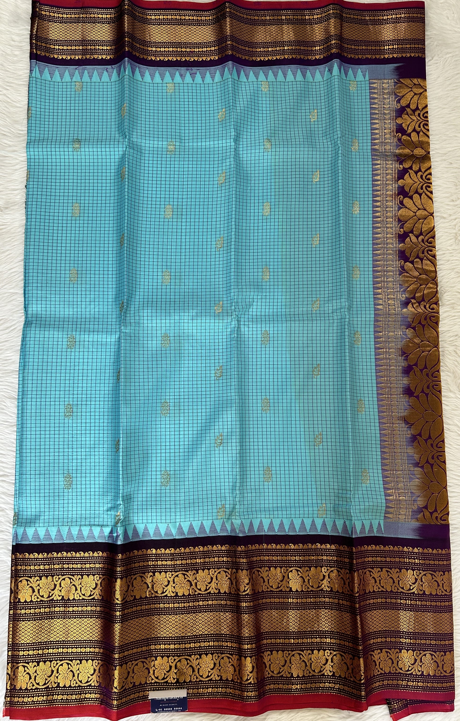 Gadwal Pattu Saree Fountain Blue colored saree complemented with a Dark Violet Kanchi Border - Sampradaya Designer Studio