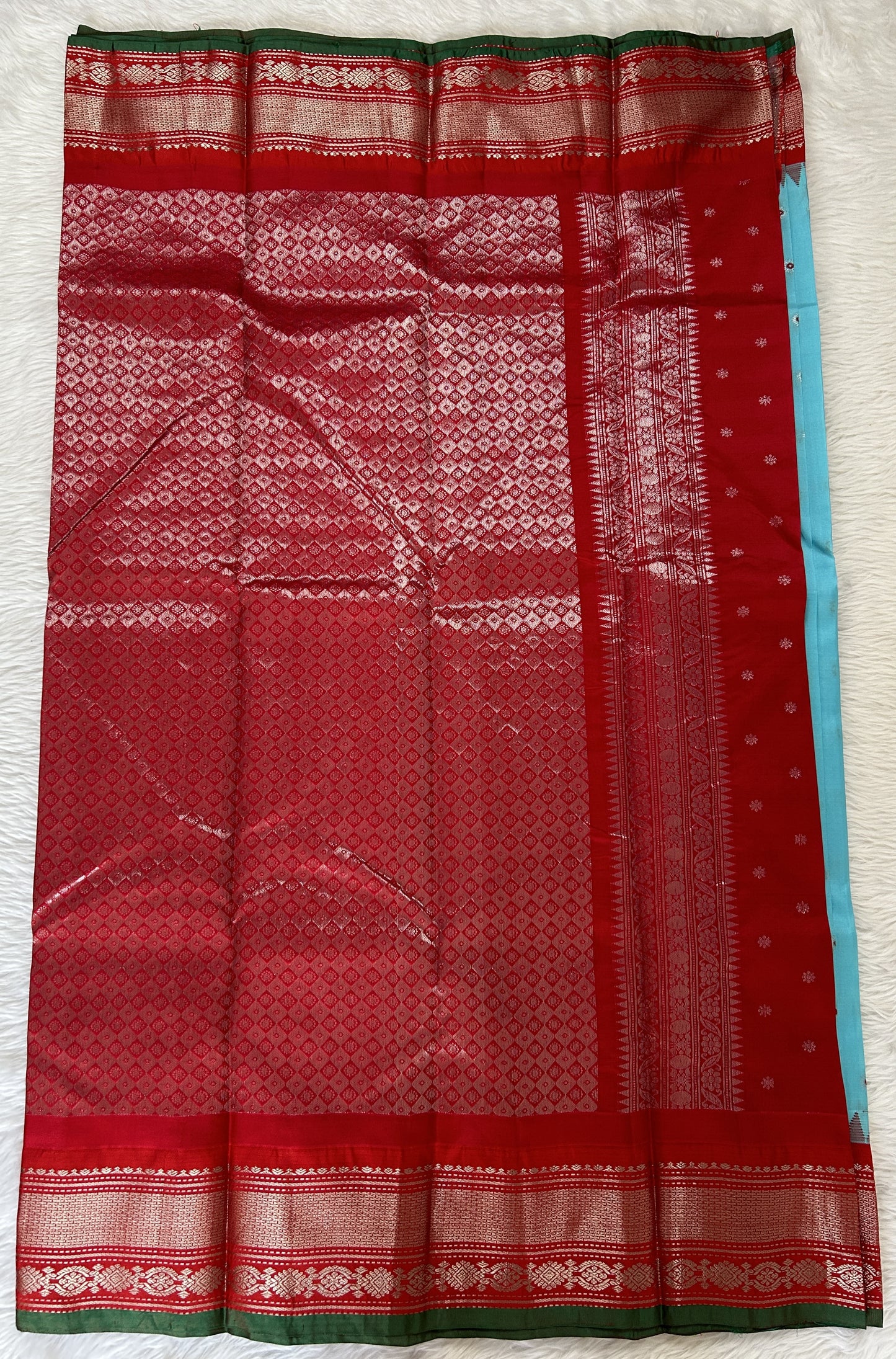 Gadwal Pattu Saree Sky Blue colored saree complemented with a Red Kanchi Border - Sampradaya Designer Studio