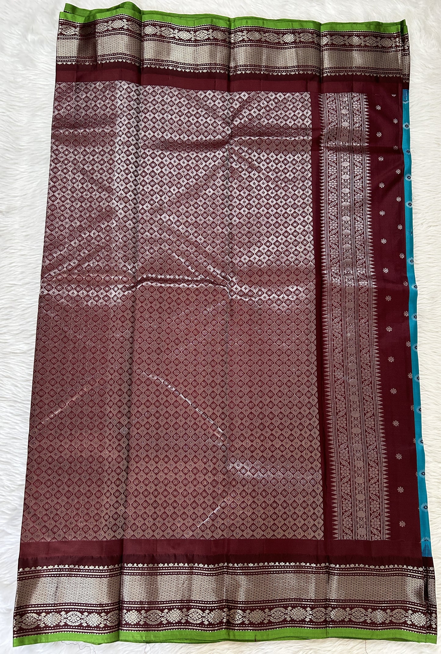 Gadwal Pattu Saree Turquoise Blue colored saree complemented with a Brown Kanchi Border - Sampradaya Designer Studio