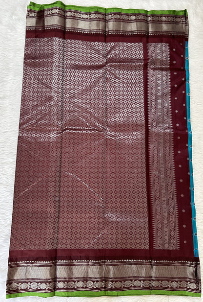 Gadwal Pattu Saree Turquoise Blue colored saree complemented with a Brown Kanchi Border - Sampradaya Designer Studio