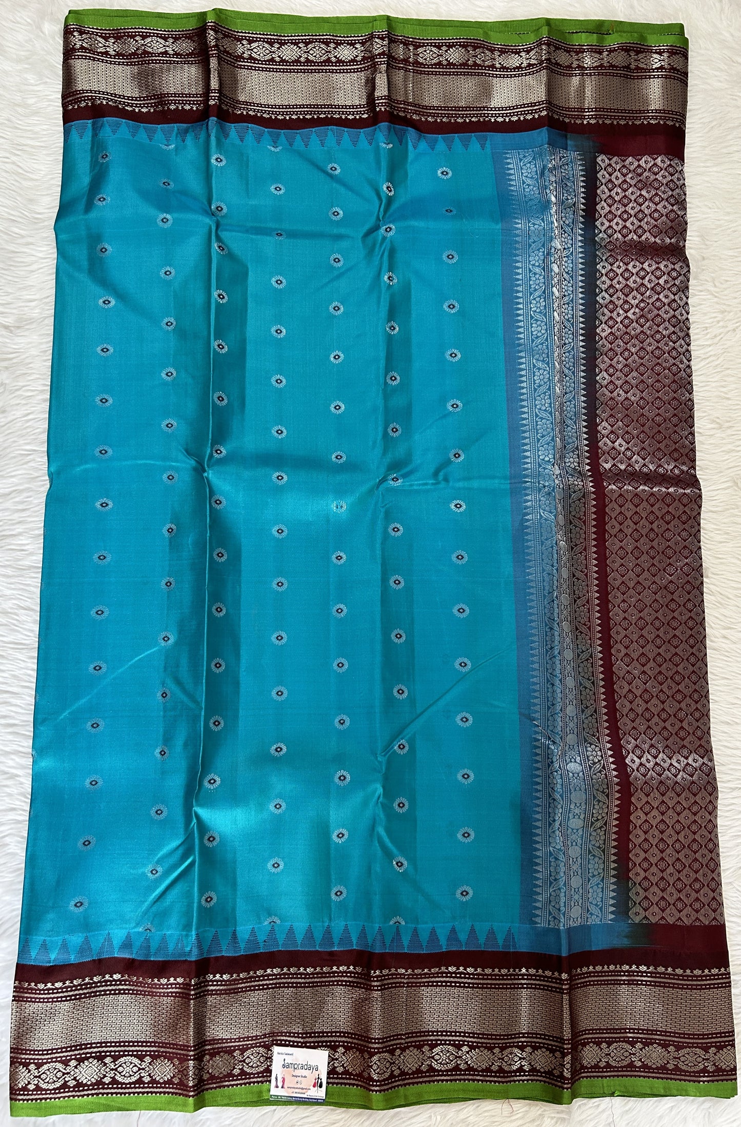 Gadwal Pattu Saree Turquoise Blue colored saree complemented with a Brown Kanchi Border - Sampradaya Designer Studio