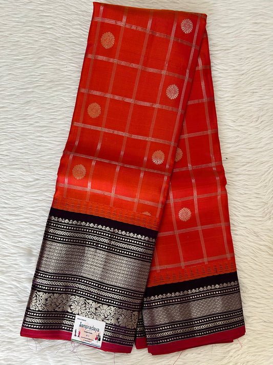 Gadwal Pattu Saree Pink Orange colored saree complemented with a Dark Violet Kanchi Border - Sampradaya Designer Studio