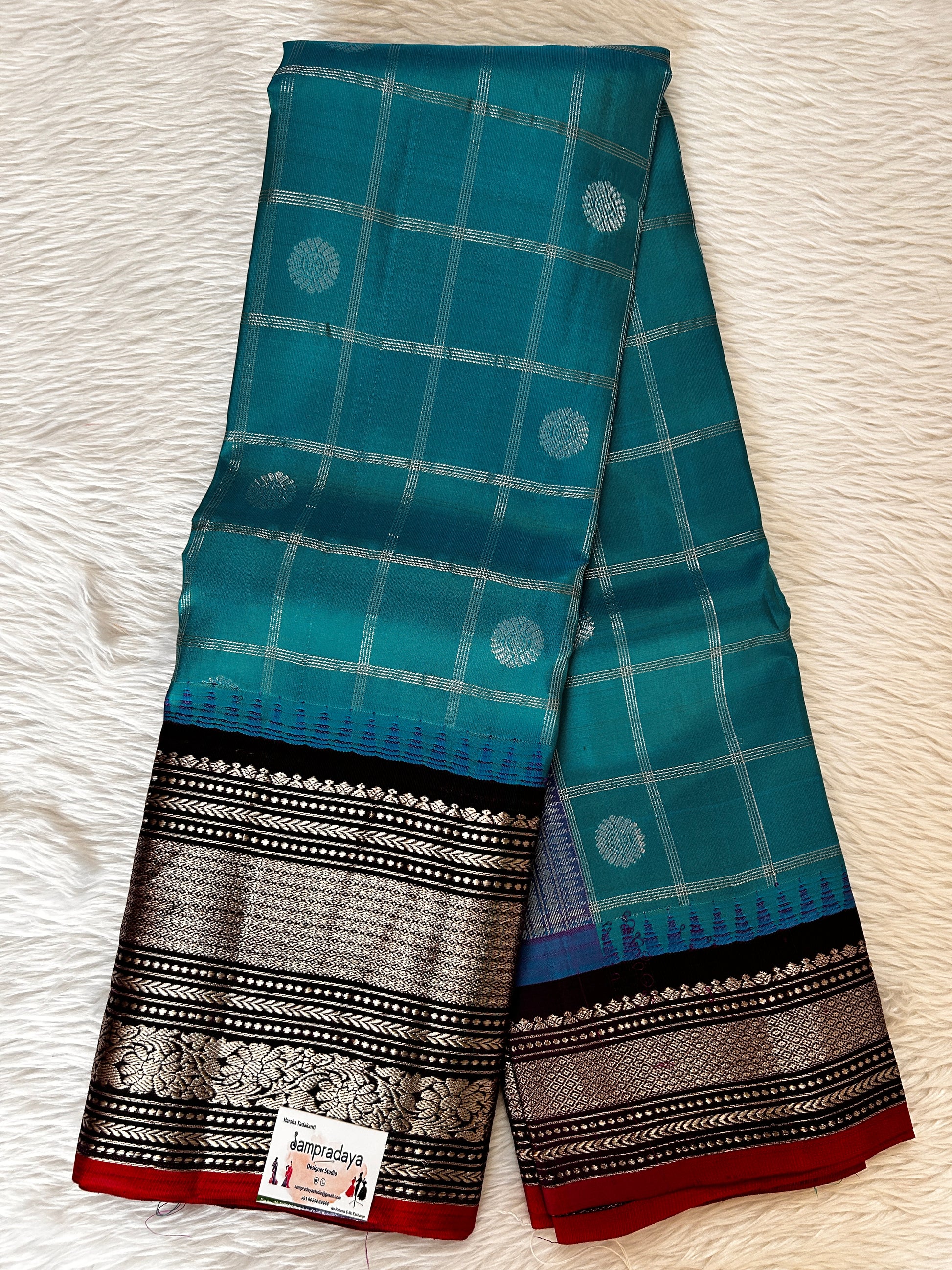 Gadwal Pattu Saree Aqua Blue colored saree complemented with a Dark Violet Kanchi Border - Sampradaya Designer Studio