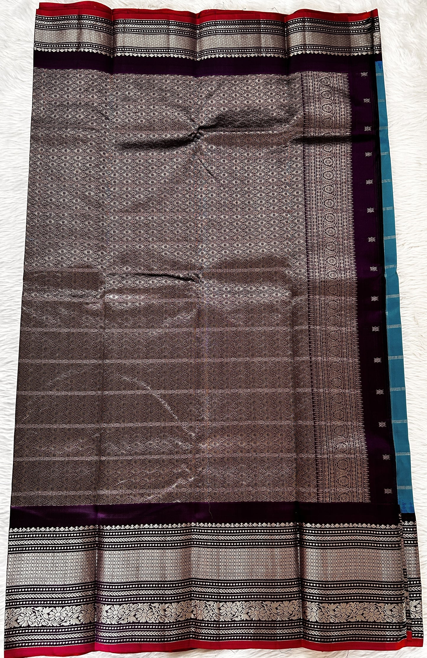 Gadwal Pattu Saree Aqua Blue colored saree complemented with a Dark Violet Kanchi Border - Sampradaya Designer Studio