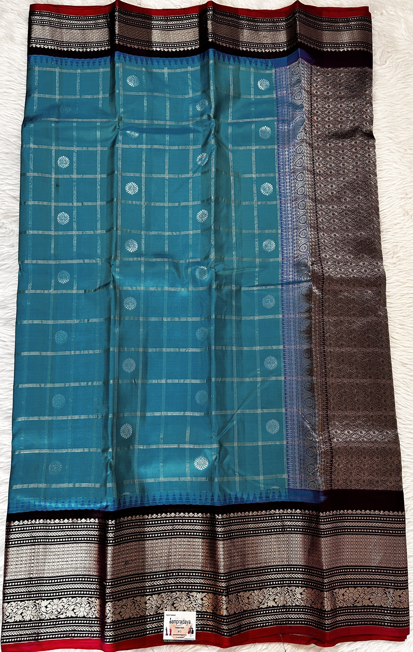 Gadwal Pattu Saree Aqua Blue colored saree complemented with a Dark Violet Kanchi Border - Sampradaya Designer Studio