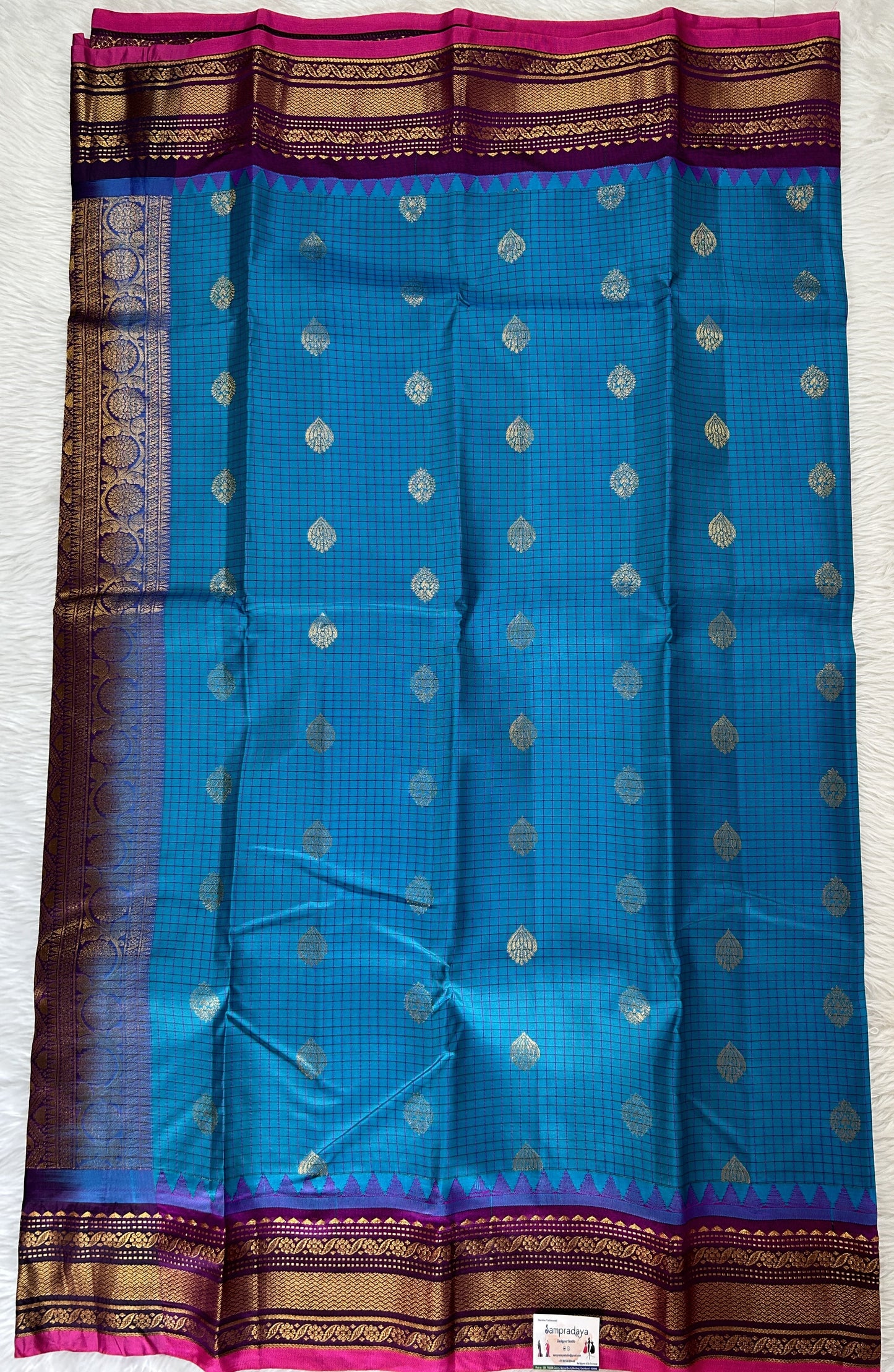 Gadwal Pattu Saree Turquoise Blue colored saree complemented with a Magenta Kanchi Border - Sampradaya Designer Studio