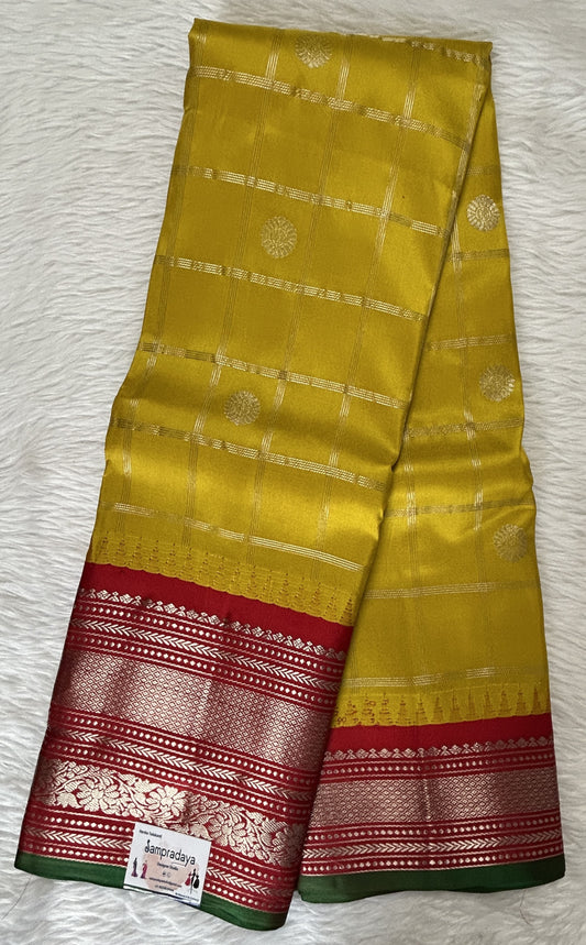 Gadwal Pattu Saree Yellow colored saree complemented with a Maroon Color Kanchi Border - Sampradaya Designer Studio