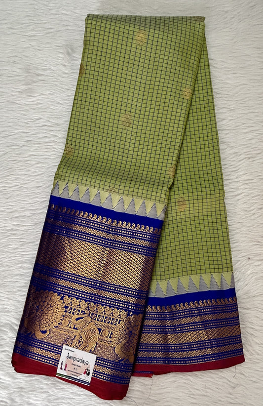 Gadwal Pattu Saree Yellow Green colored saree complemented with a Cobalt Blue Color Kanchi Border - Sampradaya Designer Studio