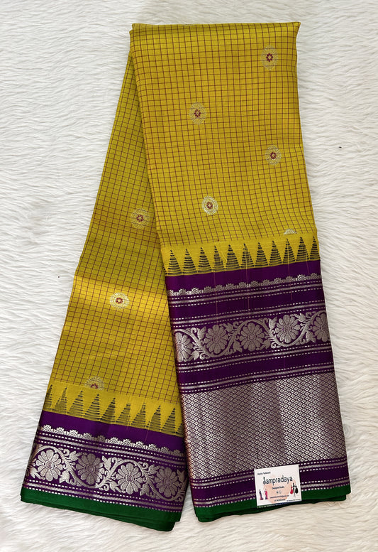 Gadwal Pattu Saree Corn Yellow colored saree complemented with a Dark Violet Color Kanchi Border - Sampradaya Designer Studio