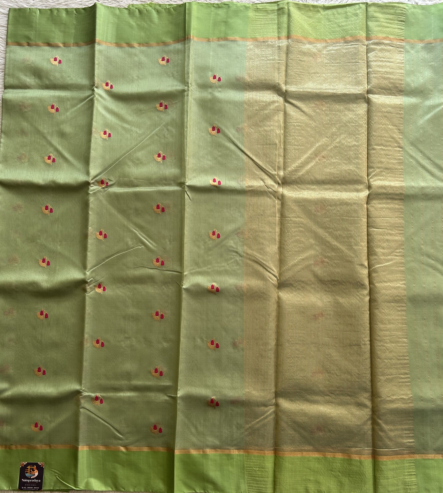 Chanderi Silk pasta Green color Elegantly Paired with a Gold Zari border - Sampradaya Designer Studio