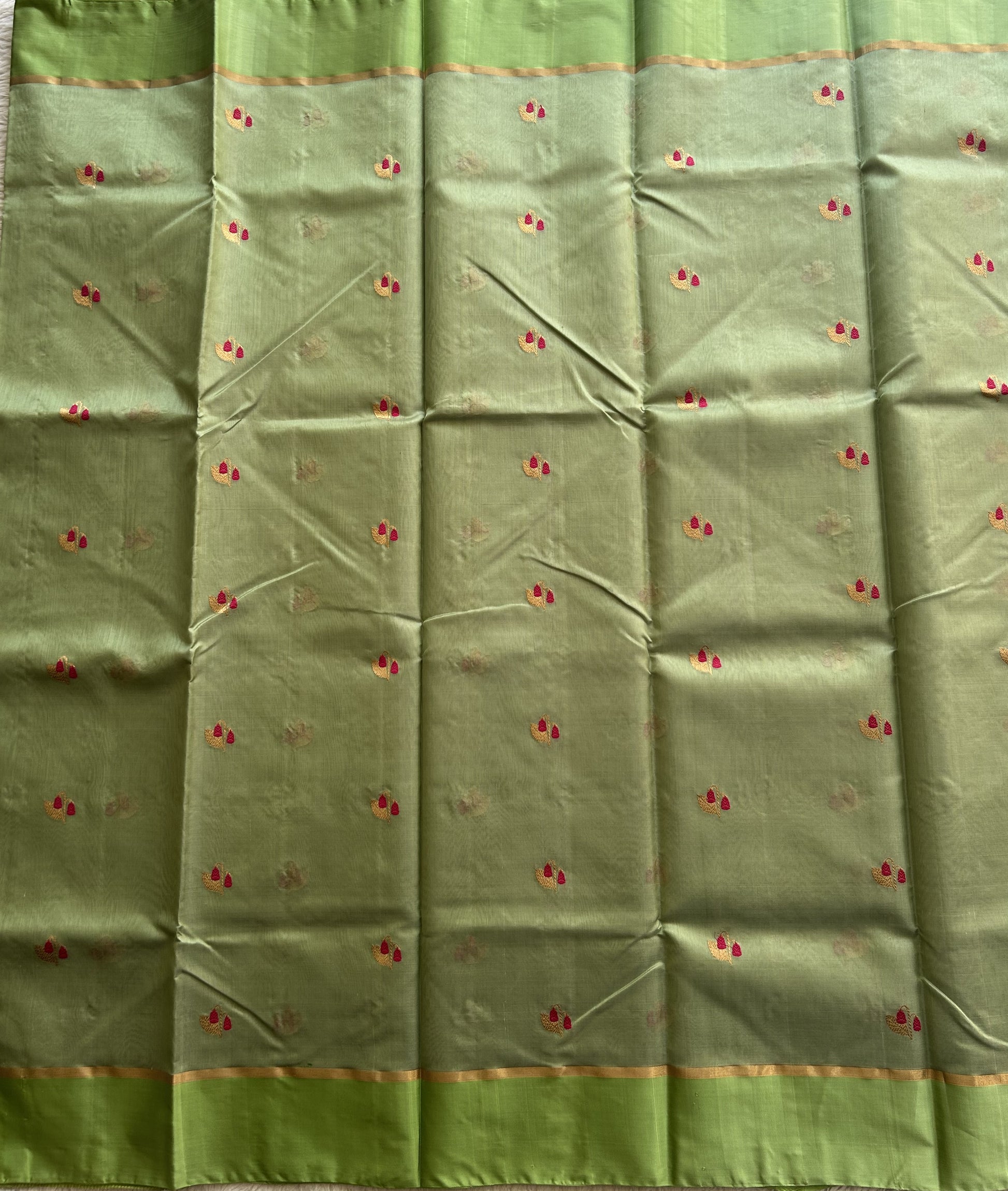 Chanderi Silk pasta Green color Elegantly Paired with a Gold Zari border - Sampradaya Designer Studio