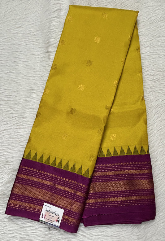 Gadwal Pattu Saree Yellow colored saree complemented with a Magenta Color Kanchi Border - Sampradaya Designer Studio