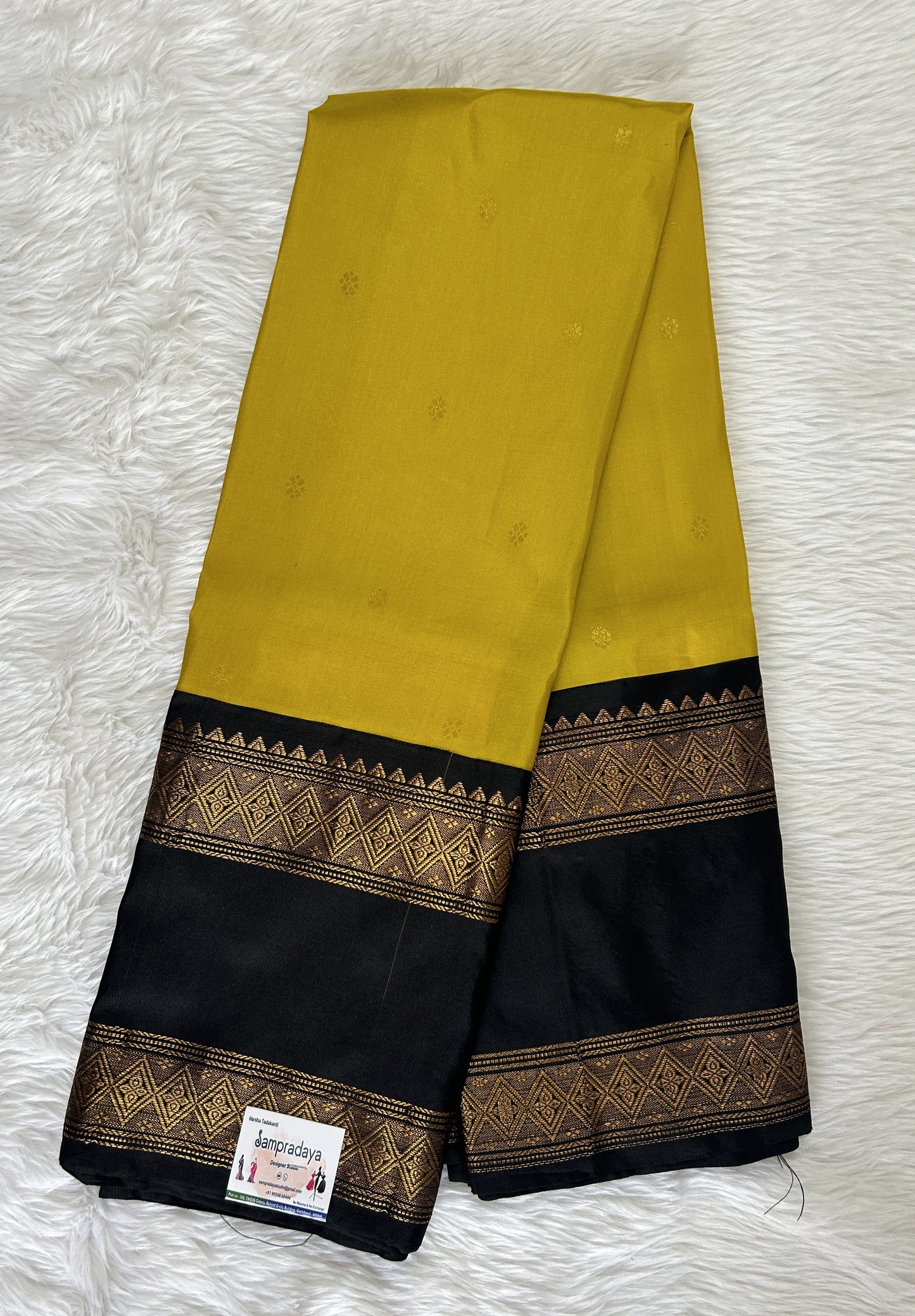 Gadwal Pattu Saree Mustard Yellow colored saree complemented with a Black Kanchi Gap Border - Sampradaya Designer Studio