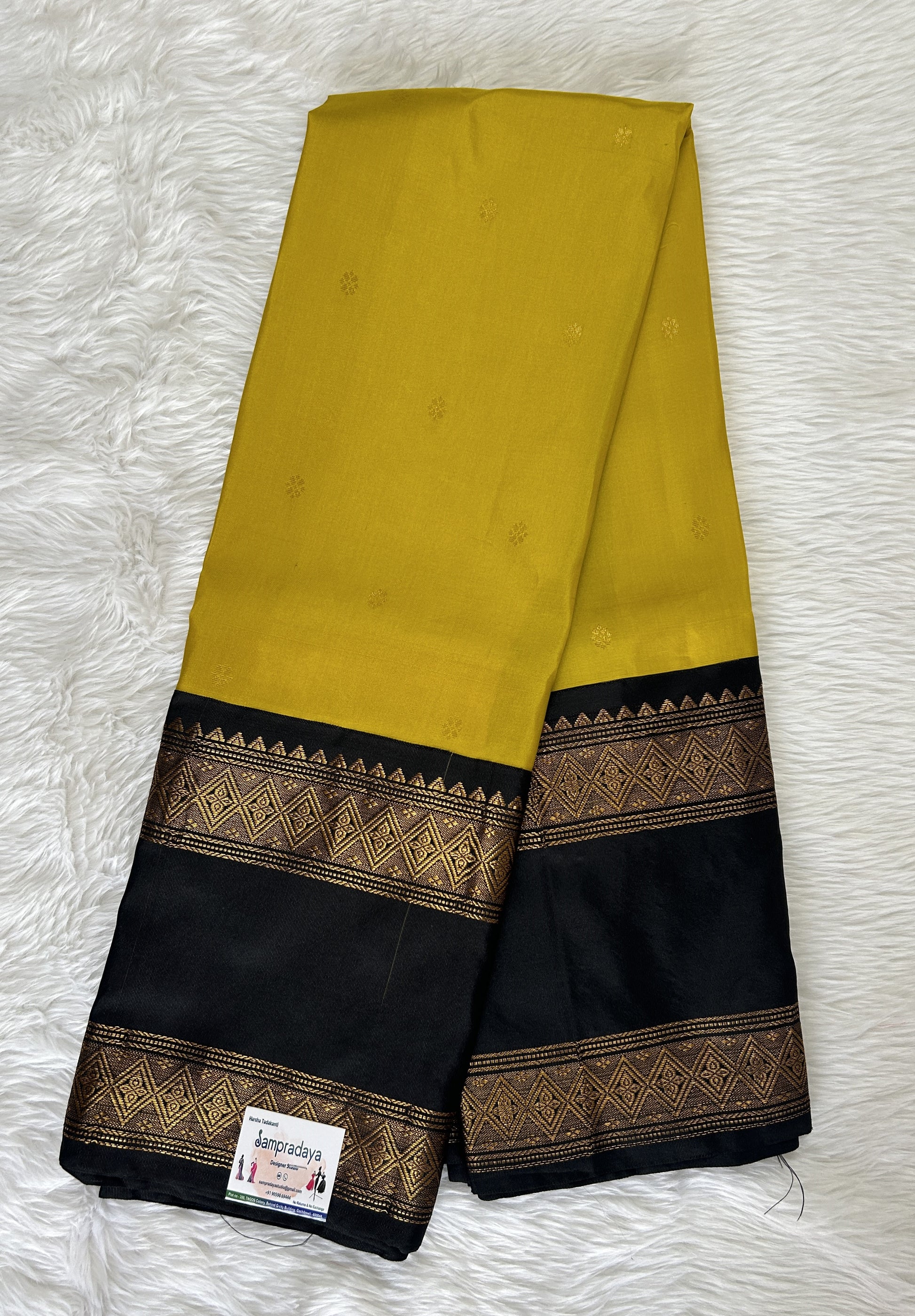 Gadwal Pattu Saree Mustard Yellow colored saree complemented with a Black Kanchi Gap Border - Sampradaya Designer Studio