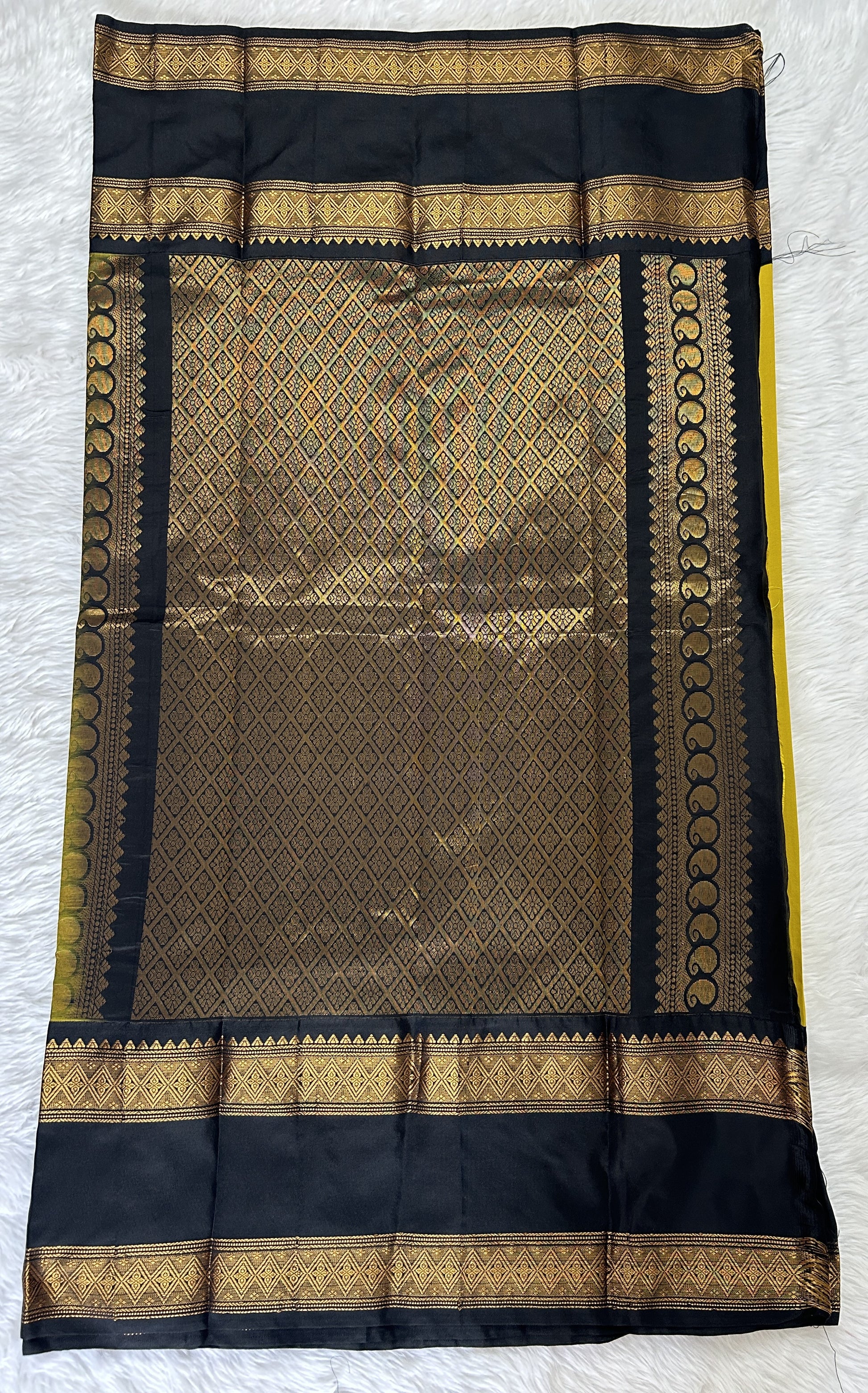 Gadwal Pattu Saree Mustard Yellow colored saree complemented with a Black Kanchi Gap Border - Sampradaya Designer Studio